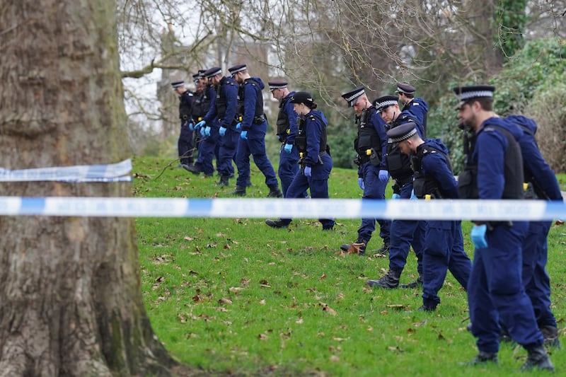 Police carry out a fingertip search on Primrose Hill after the fatal stabbing of Harry Pitman