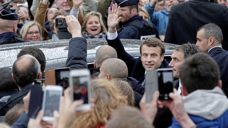 French president-elect Emmanuel Macron waves as he leaves the polling station after casting his ballot in the presidential runoff election in Le Touquet, France Picture Christophe Ena/AP 