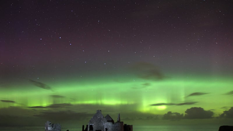 The Northern Lights dance above Dunluce Castle on the north coast of Northern-Ireland on Thursday morning&nbsp;