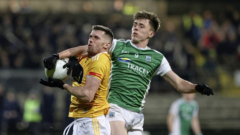 Antrim's Kevin Small and Joe McDade of Fermanagh battle for the ball. 