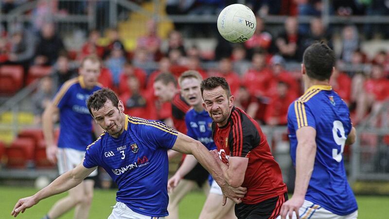 Mark Poland in action against Longford's Barry Gilleran and Darren Gallagher in the All-Ireland football Qualifier at Newry
