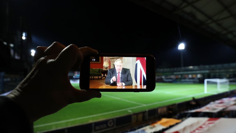 &nbsp;A video of Prime Minister Boris Johnson addressing the nation about Coronavirus on the screen of a mobile phone during the Carabao Cup third round match at Kenilworth Road, Luton.