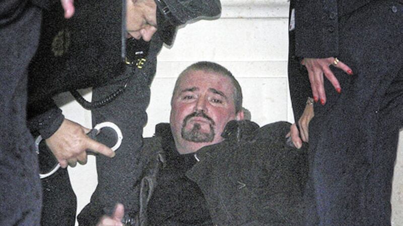 Michael Stone being restrained during a botched attack at Parliament Buildings in 2006