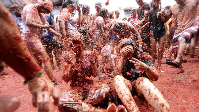 The street fight leaves both the street, its houses and participants drenched in red pulp (Alberto Saiz/AP)
