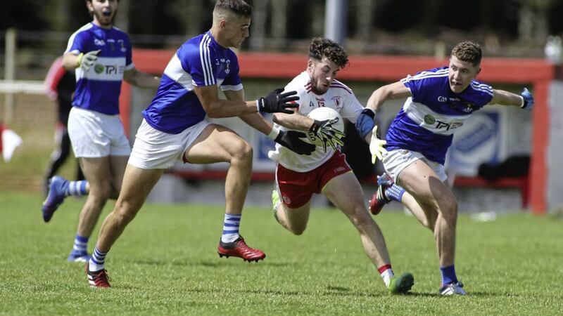 Ryan Murray comes under pressure from Conall Bohill and Conor Johnson during Sunday&#39;s championship clash in Hannahstown. The Lamh Dhearg forward was named man-of-the-match and brilliantly set up the only goal of the game for Brendan Herron. Picture by Hugh Russell 