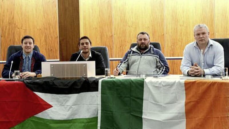 Padraig McShane (right), pictured with the Palestinian flag and a tricolour at a council chamber in Coleraine, Co Derry 