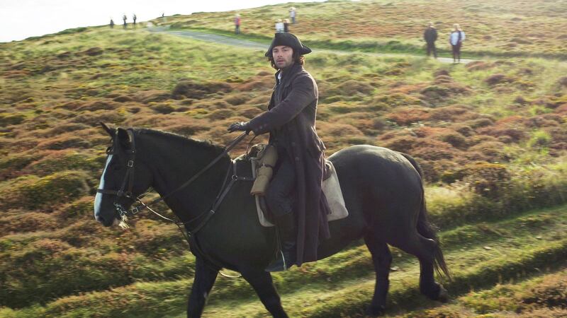 Aidan Turner rides his horse Seamus over heathland on Gwennap Head on the Cornish coast during filming recently for series three of the BBC One hit Sunday night drama Poldark. Picture by Tom Leese, Press Association&nbsp;