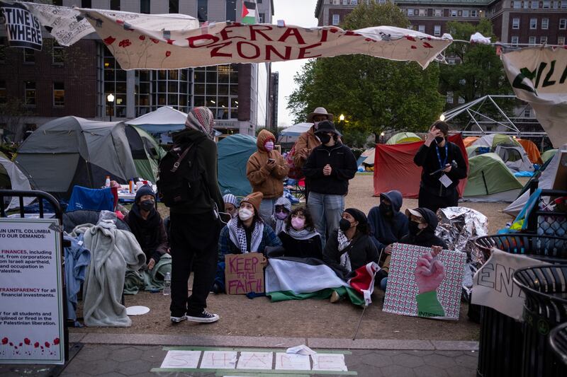 Pro-Palestinian students and protesters sit in an encampment at Columbia University (Marco Postigo Storel/AP)