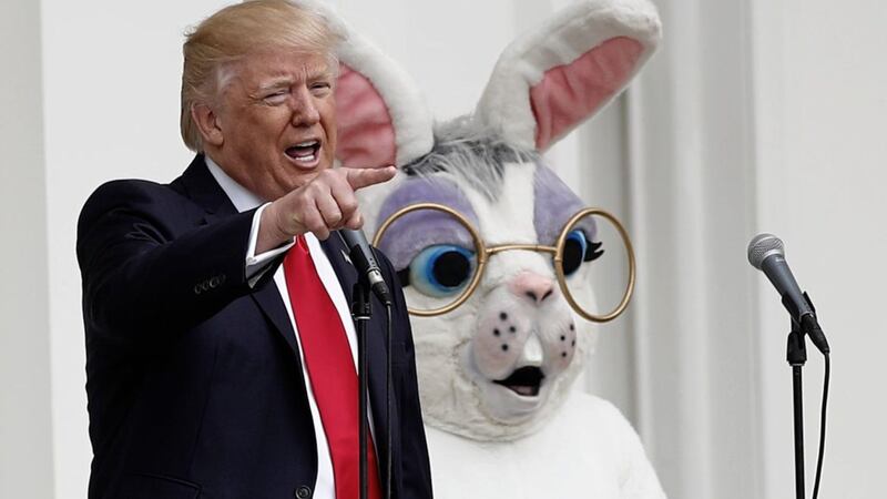 President Donald Trump, joined by the Easter Bunny, speaks from the Truman Balcony during the annual White House Easter egg roll in Washington. Picture by Carolyn Kaster, Associated Press 
