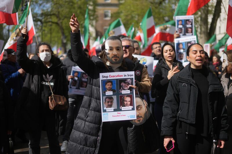 Protesters wore masks of Salehi and waved Iranian flags