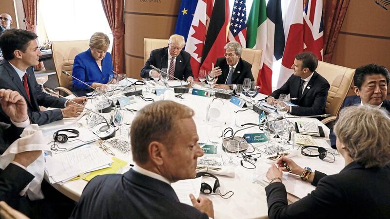 From left, Justin Trudeau, Angela Merkel, Donald Trump, Paolo Gentiloni, Emmanuel Macron, Shinzo Abe, Theresa May, Donald Tusk and Jean-Claude Juncker (unseen) sit around a table during the G7 Summit in Taormina, Sicily on Friday PICTURE: REUTERS/Jonathan Ernst/POOL 
