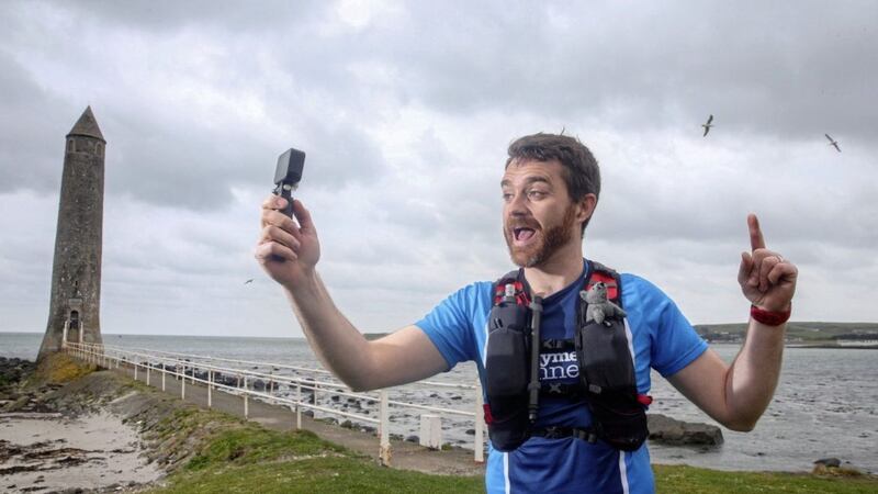 Stephen Reid mixing his two favourite things Running and Vlogging while running the route of the postponed Larne Half Marthon solo Picture Mal McCann. 