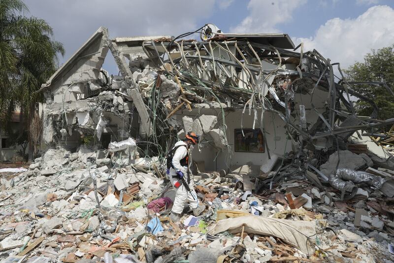 An Israeli soldier walks by a house destroyed by Hamas militants in Kibbutz Be'eri. Picture by AP Photo/Baz Ratner