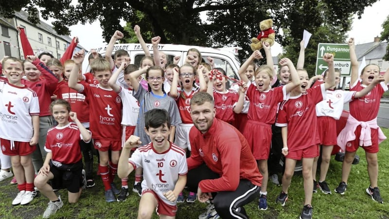 Tyrone player Michael Conroy with pupils of St John's PS, Moy ahead of the All-Ireland football final. Picture by Hugh Russell
