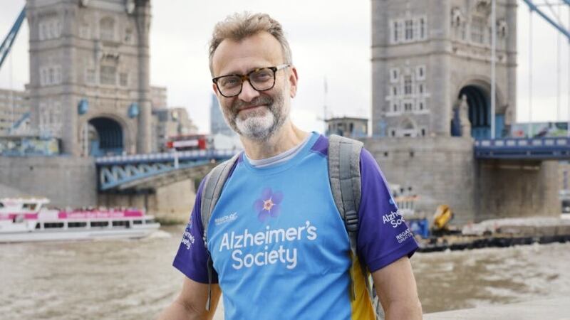 The comedian is completing a 13-mile trek for the Alzheimer’s Society in London.
