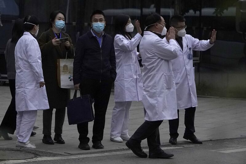 Chinese medical staff wave farewell to a World Health Organization team  during their visit to the Hubei Provincial Hospital of Integrated  Chinese and Western Medicine also know as the Hubei Province Xinhua  Hospital in <span class="red">Wuhan</span> in central China's Hubei province on Friday, January 29, 2021 (AP Photo/Ng Han Guan)
