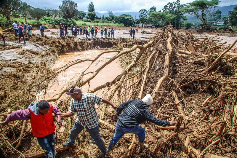 People try to clear the area after a dam burst in Kenya (Patrick Ngugi/AP)