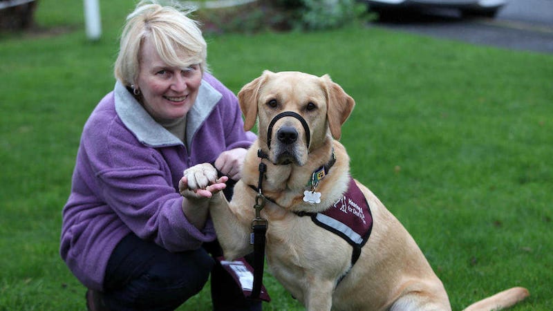 Hearing dog owner Patricia Moore with Kally at their Co Antrim home Picture by Ann McManus 