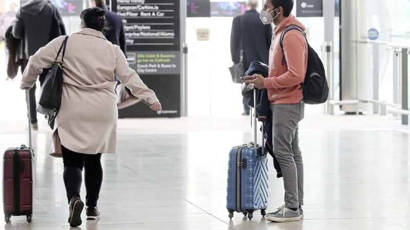 A man wearing a face mask in the arrivals hall of Terminal 2 at Dublin Airport