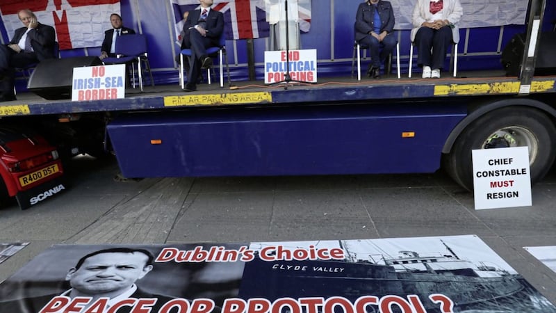 TUV leader Jim Allister sits close to a controversial banner which appeared at at an anti-protocol protest last week 