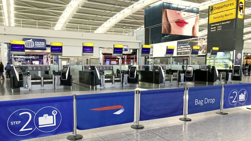 Deserted check-in desks at Heathrow&#39;s Terminal Five after flight schedules were slashed by IAG. Photo: Steve Parsons/PA 