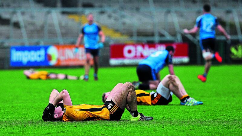 DOWN AND OUT: Pomeroy players show their disappointment after their defeat to St Colmcille&rsquo;s in the All-Ireland Club IFC semi-final at the Athletic Grounds  Picture: Philip Walsh