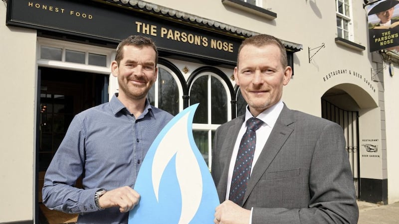 Ronan Sweeney of Balloo Inns (owner of the Parson&rsquo;s Nose) is congratulated by Oliver Mars from Phoenix Natural Gas on being the first business to connect to the extended natural gas network 
