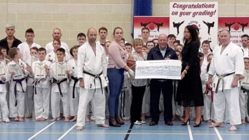 The Geddis family, members of the Zanshin Shotokan Karate Club, friends and family presented the Kevin Bell Reparation Trust with a cheque for &pound;10,000 