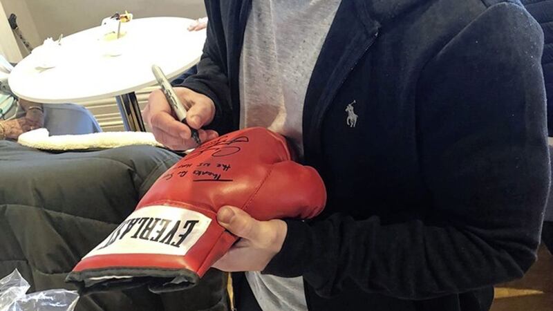 A Carl Frampton signed boxing glove raised &pound;500 for NI Hospice 