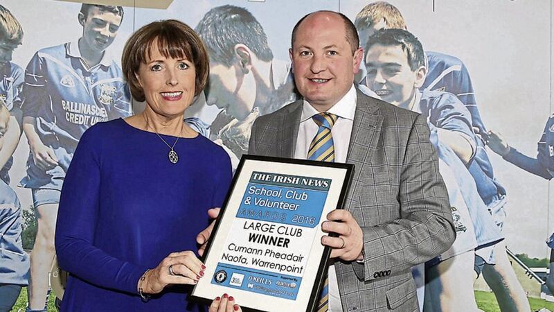 Anne McCormack collecting the 2016 Large Club Award for St Peter&rsquo;s, Warrenpoint, from sponsor Mark Regan, CEO of Kingsbridge Private Hospital at The Irish News School, Club and Volunteer Awards. Picture by Hugh Russell 