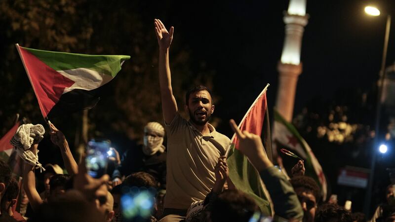 People chant anti-Israel slogans while waving Palestinian flags during a rally celebrating the attacks that the militant Hamas group carried out against Israel, in Istanbul, Turkey (Khalil Hamra/AP)
