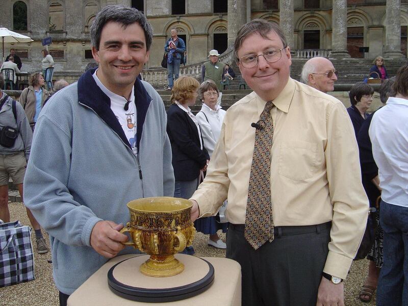 Antiques expert John Sandon, right, with the 17th century slipware cup he valued on Antiques Roadshow