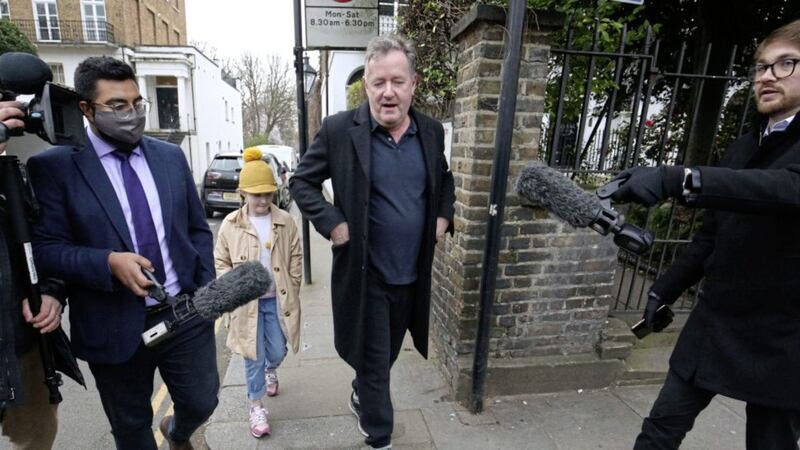 Piers Morgan (centre) speaks to reporters as he walks his daughter Elise to school in Kensington, central London, the morning after it was announced by broadcaster ITV that he was leaving as a host of Good Morning Britain. Picture by Jonathan Brady/PA Wire 