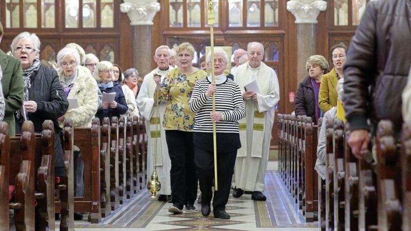 Pat McGlory carries the cross at Clonard. Picture by Cliff Donaldson 