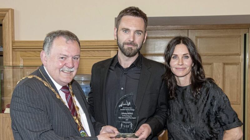 Songwriter Johnny McDaid (centre) receiving an award at Derry's Guildhall with his fianc&eacute;e actress Courtney Cox and councillor Maol&iacute;osa McHugh. Picture by Martin McKeown