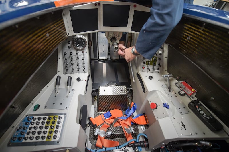 An engineer tightens bolts in the cockpit after fitting a footplate on the BLOODHOUND SSC at the Bloodhound Technical Centre in Avonmouth (Ben Birchall/PA)