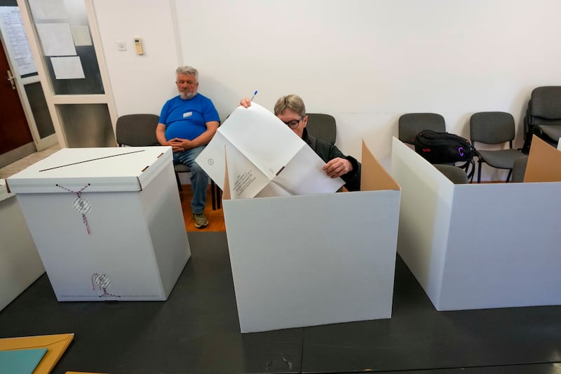 A voter prepares her ballot at a polling station in Zagreb, Croatia (Darko Vojinovic/AP)