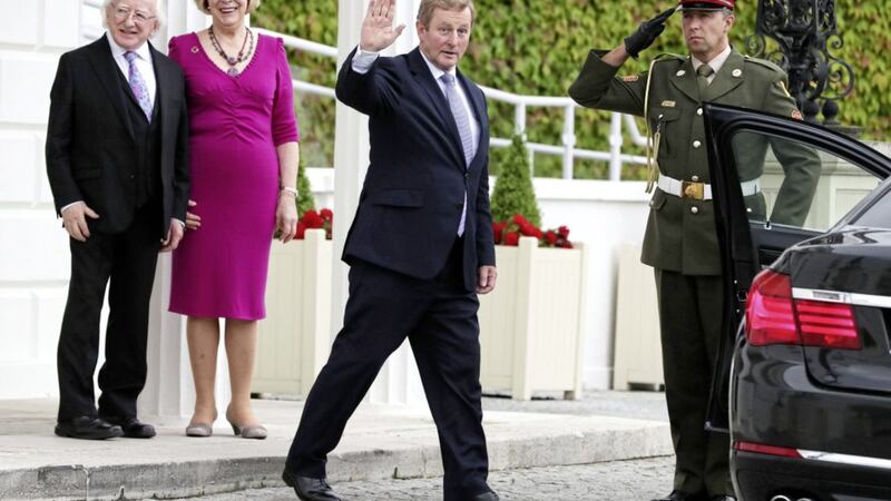 President Michael D Higgins and wife Sabina Coyne watch outgoing taoiseach Enda Kenny, centre, leaving &Aacute;ras an Uachtar&aacute;in in Dublin, on his last day as taoiseach PICTURE: Brian Lawless/PA 
