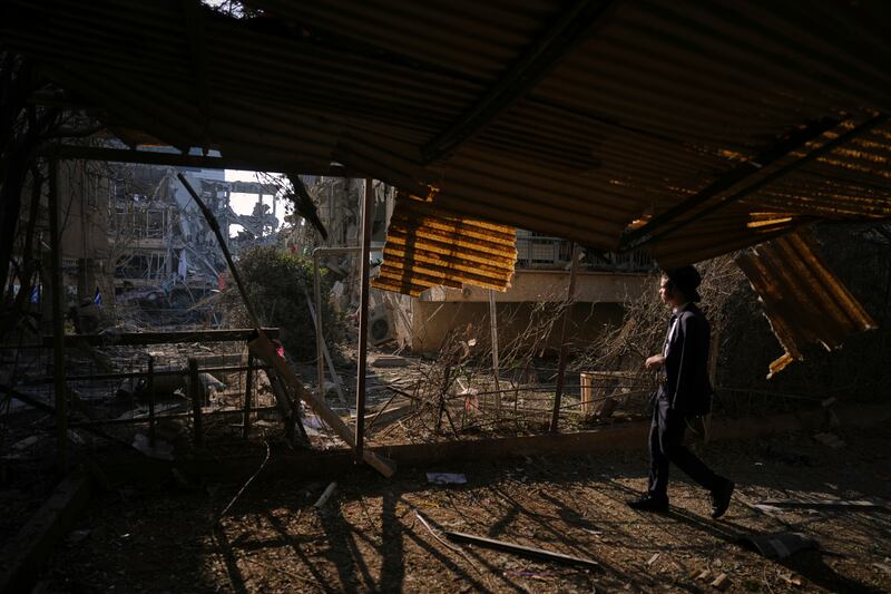 A person looks out at a destroyed residential building that was hit by a missile fired from Iran, in Ramat Gan near Tel Aviv, Israel (Ariel Schalit/AP)