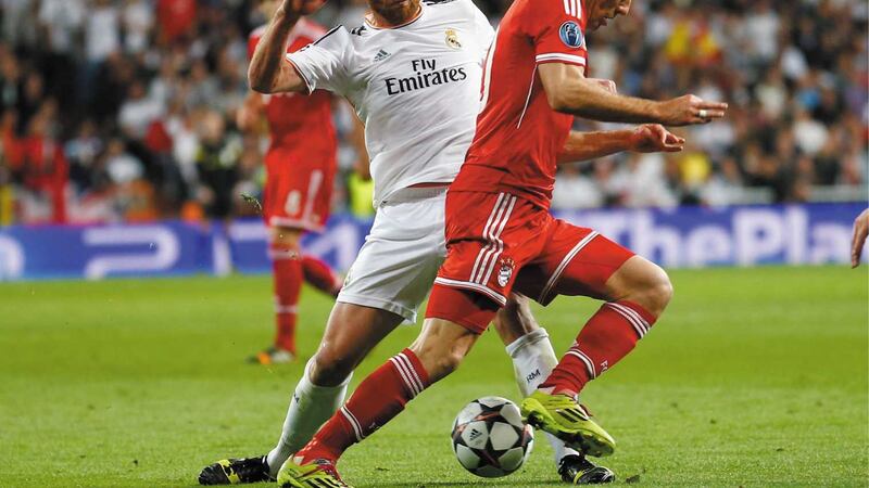 Xabi Alonso in action against Bayern Munich's Arjen Robben