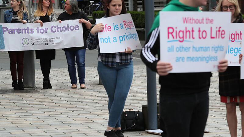 Pro-choice and anti-abortion campaigners outside the Royal Courts of Justice, Belfast, where the Court of Appeal allowed an appeal against a lower court's ruling that abortion legislation was incompatible with the UK's Human Rights Act&nbsp;