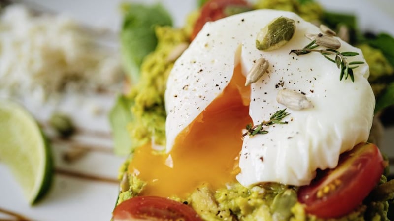 Avocado with a poached egg on sourdough toast for breakfast &ndash; yummy and nutritious 