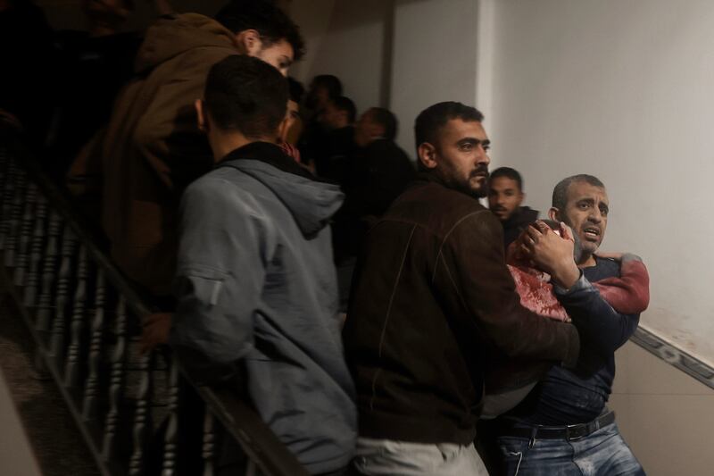 Palestinians evacuate a wounded boy following Israeli strikes on the maternity ward at Nasser Hospital in the town of Khan Younis, southern Gaza Strip, on Sunday (Mohammed Dahman/AP)