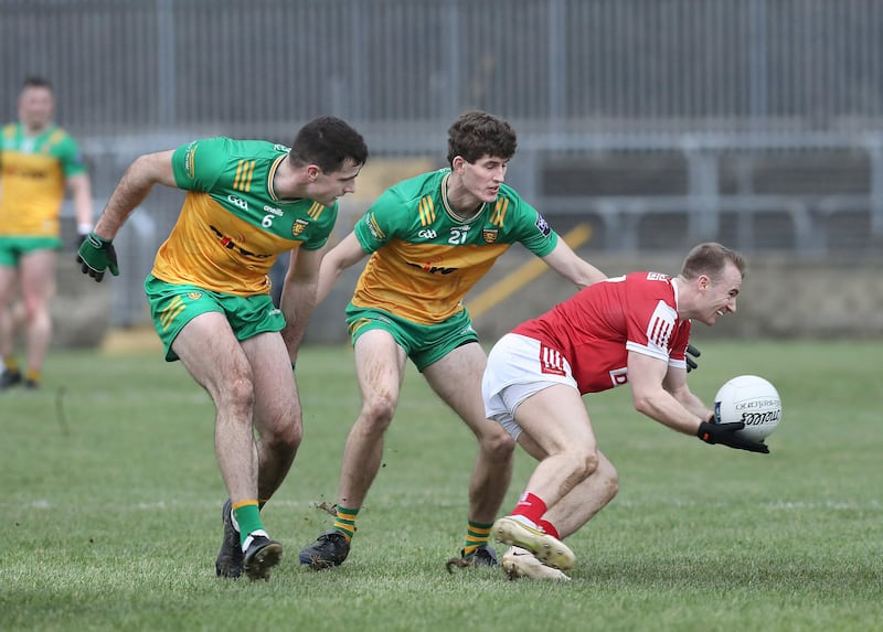 Donegal's Caolan McGonagle and Domhnall MacGiolla Bhride with Matty Taylor of Cork