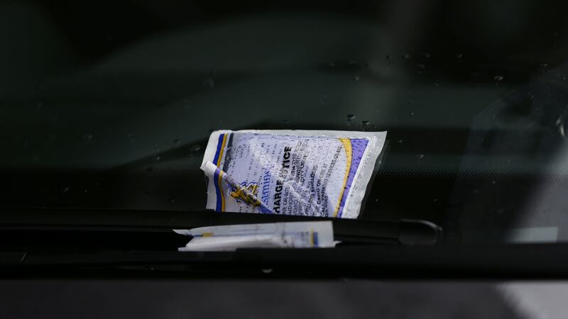 A parking ticket placed on the windscreen of a car in Westminster, London.