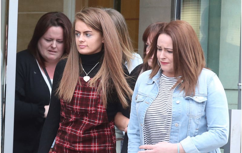 The mother of Caragh Walsh,Tammie-Louise Walsh (pictured in red), on her way out of the inquest in Belfast. Picture by Hugh Russell.&nbsp;