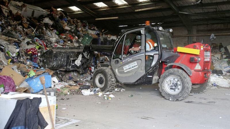 Rubbish being removed from a storage unit at Edenderry Mill off the Crumlin Road yesterday. Picture by Mal McCann 