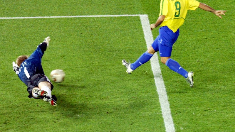 Brazil's Ronaldo beats Germany's keeper Oliver Kahn to score in the 2002 World Cup final in Yokohama, Japan