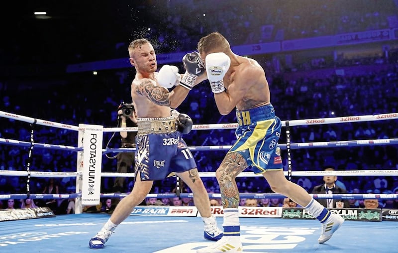 Will we meet again? Josh Warrington and Carl Frampton trade blows during their IBF featherweight title fight in Manchester in December 