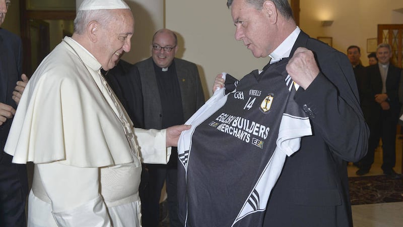 Eglish parish priest Fr Michael Toner presents Pope Francis with an Eglish GAA jersey during a visit to the Vatican 